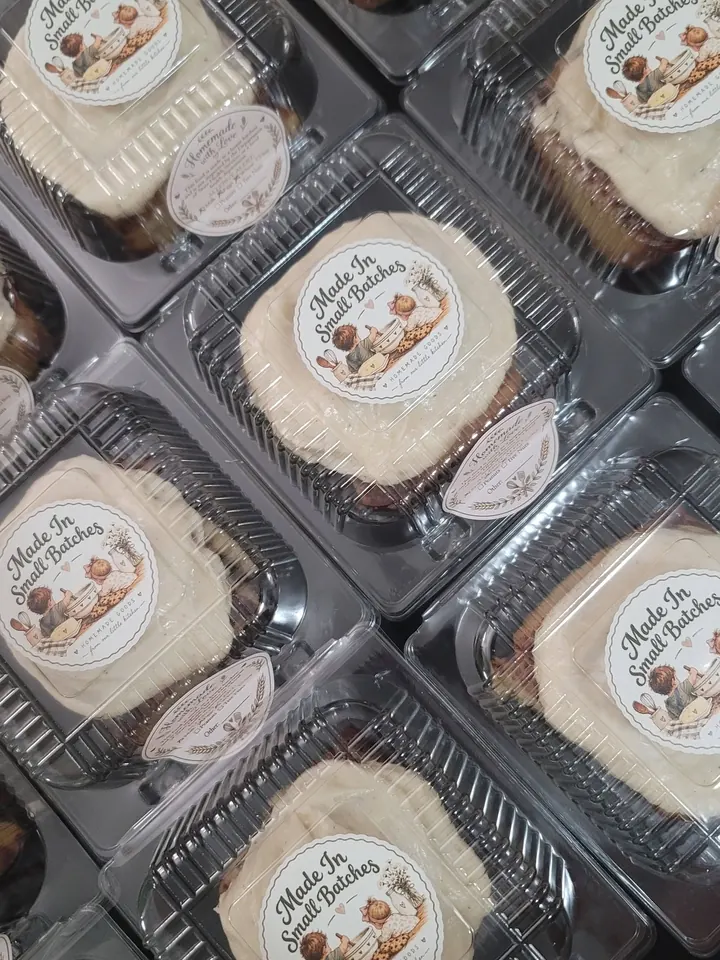 Individually boxed cinnamon rolls with Made In Small Batches labels ready for a group order